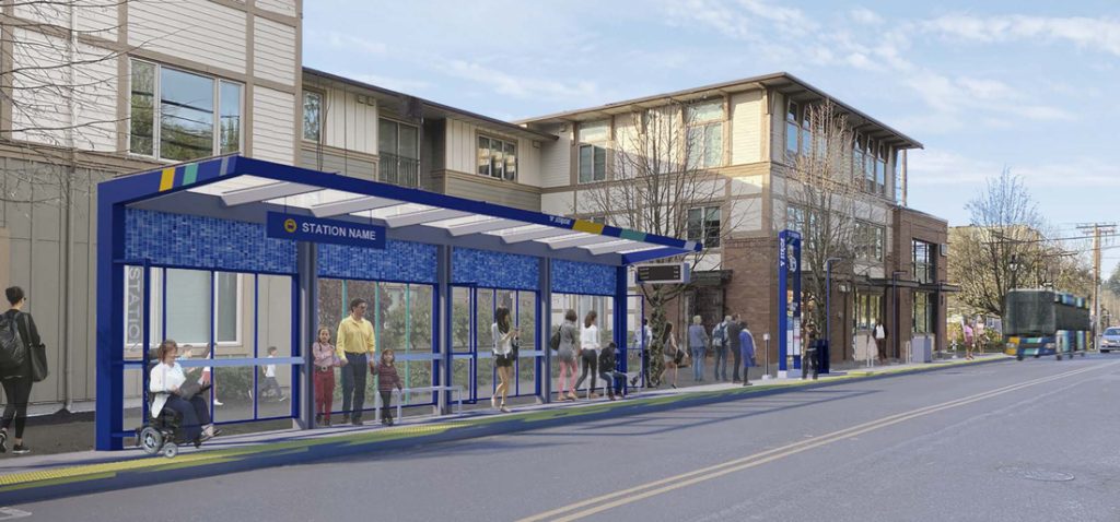 A Stride bus enters the station in a bus-only lane. Pedestrians, bicyclists, and parked cars are in the station area.