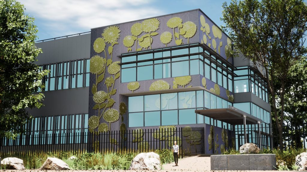 Trees and grass surround Bus Base North’s two-story building, which is connected to a parking structure.
