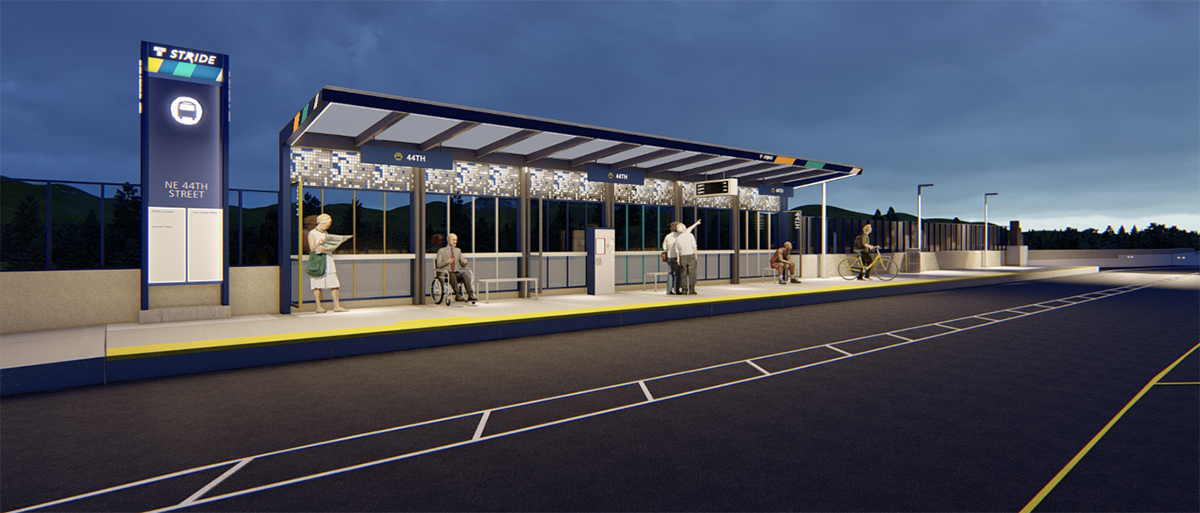 Stride station next to a road at night showing large signage, a covered shelter, and lighting.
